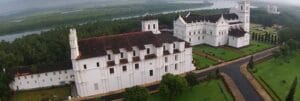 Basilica of bom jesus church is white in colour and situated in a green field