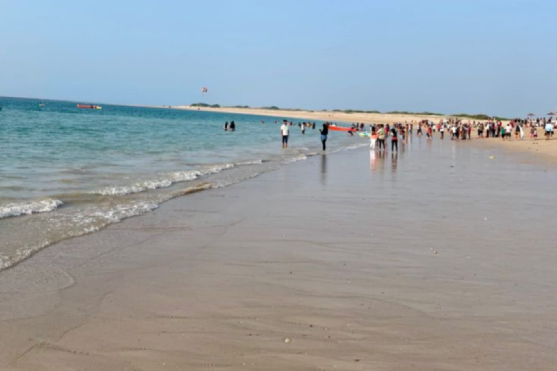 Lots of people walking near the sea beach