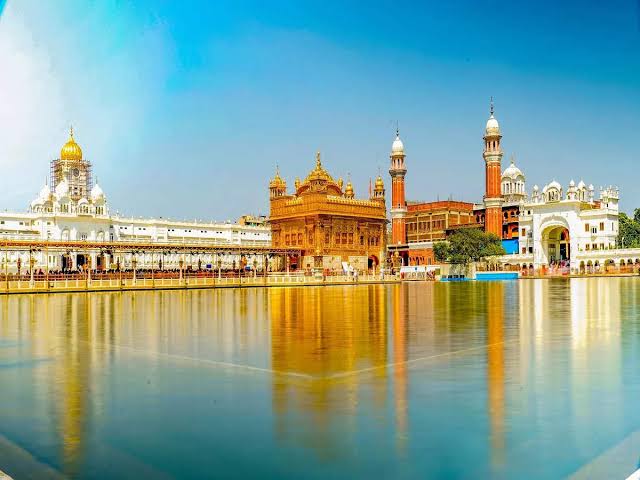 The Golden temple and a lake ni front and its mirror image showing on lake water Winter Destinations In India