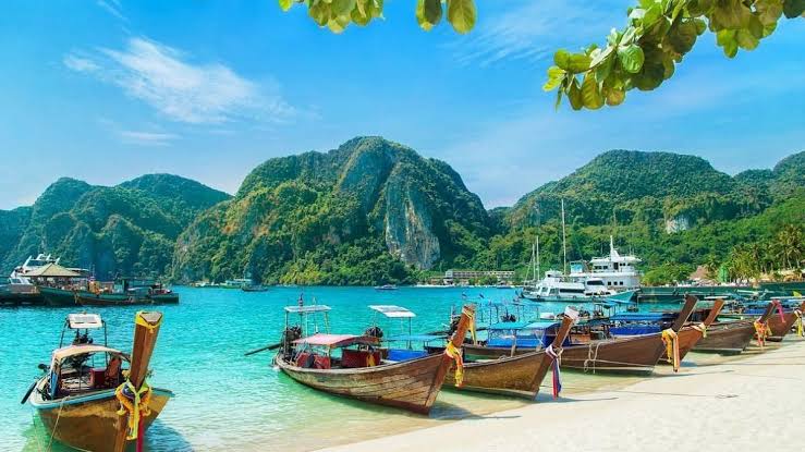 boats are lying on nicobar islands sea water and some mountain are visible Places to visit in West India